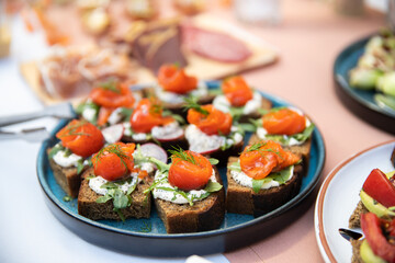 Food catering appetizers snacks on a tray on table.