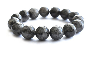 Black rutilated quartz bracelet on white background.  