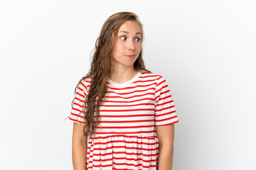 Young caucasian woman isolated on white background making doubts gesture looking side