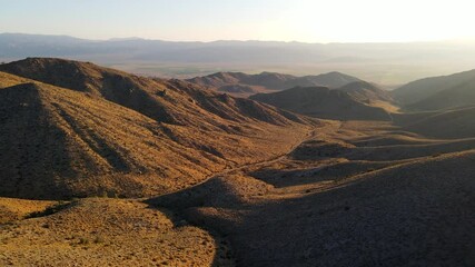 Dawn aerial shot of some remote desert mountains in California near the Nevada border - Powered by Adobe