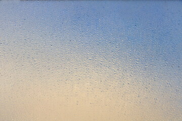 texture of many droplets on mirror orange and blue tone color like sunset or sunrise  for background
