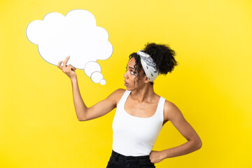 Young african american woman isolated on yellow background holding a thinking speech bubble
