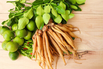 Fresh vegetables and herbs isolated on wooden background closeup.