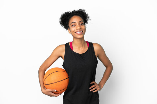 Young basketball player latin woman isolated on white background posing with arms at hip and smiling