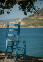 lonely chair on a rock against the background of the sea