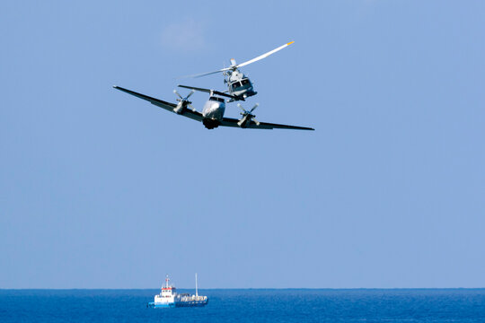 Kalkara, Malta - September 23, 2016: Armed Forces of Malta Hawker Beechcraft B200 King Air and AgustaWestland AW-139 in a flypass over the sea.