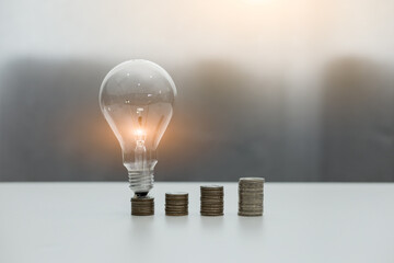 Light bulb Energy saving and a coin glass on the floor background with icons