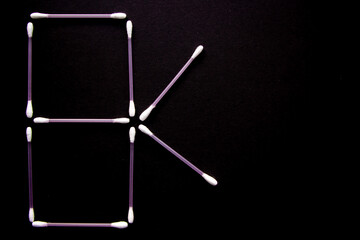 a lot of cotton buds on black background