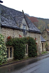 Fototapeta na wymiar Historic homes covered in ivy in Castle Combe, England