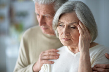 Close up portrait of sad senior couple posing