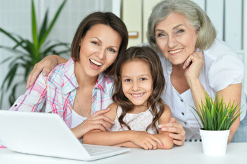 Close up portrait of happy family using laptop