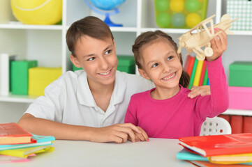 Fototapeta premium Close up portrait of brother and sister playing