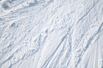 Pattern on white snow. Ski tracks. 
