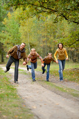 Portrait of family of four in park