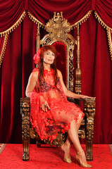 portrait of mature redhead queen wearing red clothing