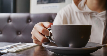 Woman enjoy her hot coffee in cafe