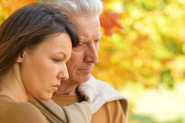 Fototapeta premium Close up portrait of sad woman and senior man hugging