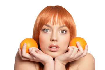 Portrait of young woman posing with oranges