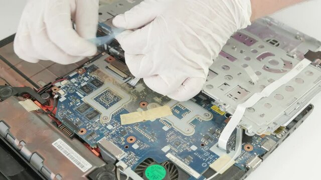 The wizard installs a new part of the laptop. Laptop repair. Computer repair service