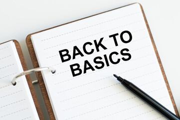 BACK TO BASICS text on an open bloncot next to a black marker