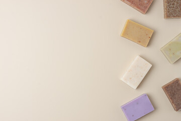 Soap on beige background. Flat lay, copy space.