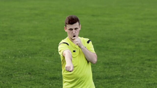 Referee goes watching VAR or violation of the rules and shows a penalty, yellow or red card . Concept of sport, rules violation, offside.