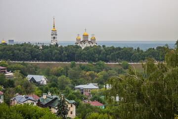 VLADIMIR, RUSSIA - AUGUST, 11, 2021: Church of the Transfiguration of the Lord in the old town on a cloudy day among green trees