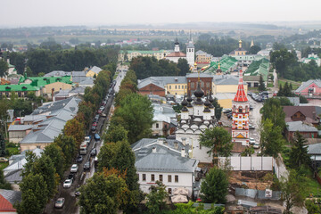 Fototapeta na wymiar panoramic top view of the old town with historical architecture among the green foliage of trees and a cloudy summer day in Suzdal Russia