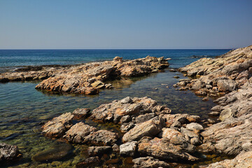 Fototapeta na wymiar Stones in Aegean Sea during Sunny Day in Rhodes. Beautiful View of Rock in Water in Greece.