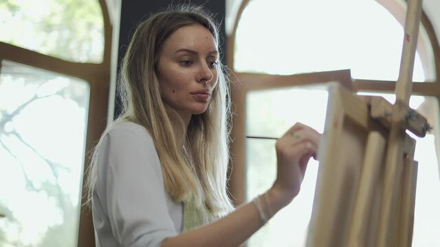 Concentrated woman drawing a picture at art studio