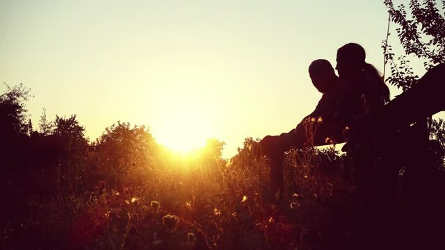 Man and woman at sunset in the countryside.