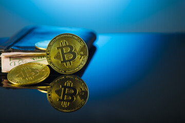 Gold bitcoins on a blue background. Close-up. Minimalism. Cryptocurrency, money, profit. Popular worldwide electronic currency. Economy, finance, bank, electronic bank.