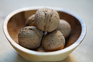 a wooden bowl with walnuts