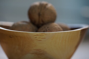 a wooden bowl with walnuts