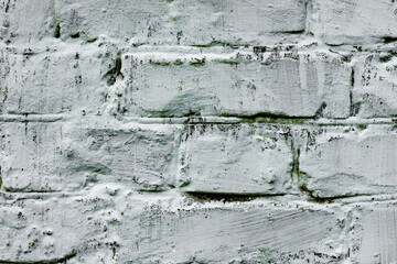 Texture of a brick wall with cracks and scratches which can be used as a background