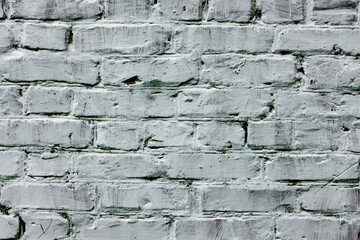 Texture of a brick wall with cracks and scratches which can be used as a background