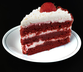A piece of cake with protein cream, in a white plate on a black background