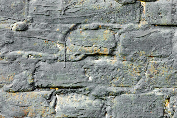 Texture of a brick wall with cracks and scratches which can be used as a background