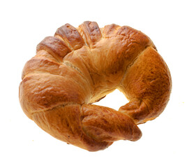 Confectionery product ruddy bun in the shape of a donut, view from the top, on a white background in isolation