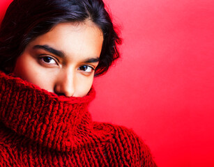 young pretty indian girl in red sweater posing emotional, fashion hipster teenage, lifestyle people concept