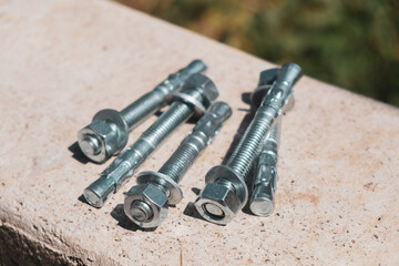 Concrete anchor screws for fixing metal structures isolated group in the concrete wall - obrazy, fototapety, plakaty