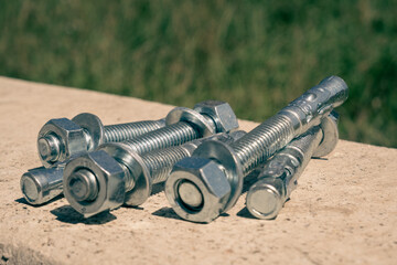 Concrete anchor screws for fixing metal structures isolated group in the concrete wall