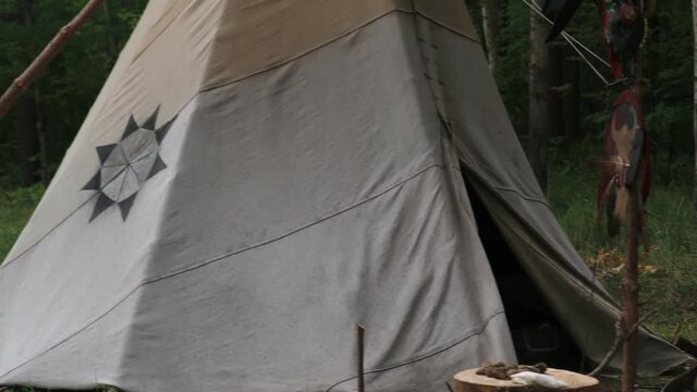 Forest home of the Indians. Wigwam indian teepee. The life of nomadic tribes. The wigwam stands in the forest. A hut of nomadic peoples. A home of Indians. tippi aka in the forest.