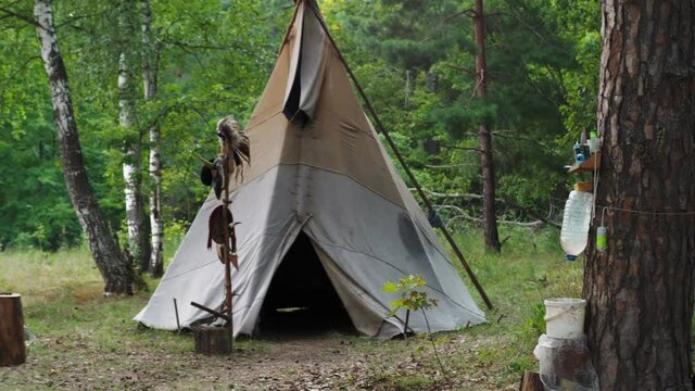 Forest home of the Indians. Wigwam indian teepee. The life of nomadic tribes. The wigwam stands in the forest. A hut of nomadic peoples. A home of Indians. tippi aka in the forest.
