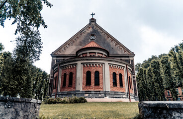 Round red brick basilica surrounded by green trees (967)