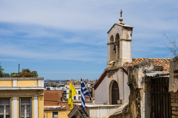 Scenic cityscape of the district of Plaka in Athens, Greece. Small church with national greek flag.