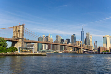 Cityscape of Brooklyn Bridge and Lower Manhattan skyscraper from beach of Brooklyn Bridge Park on June 18, 2021 in Brooklyn New York City.