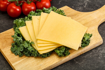 Sliced Gauda cheese over board