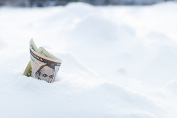 five dollars in a snowdrift, money sticking out of the snow
