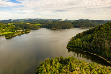 Fototapeta premium The Orlik Reservoir on Vltava River is largest hydroelectric dam in Czech Republic. Aerial view to important source of sustainable energy in European Union.